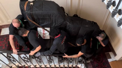 porter pianodans l'escalier